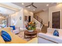 Comfortable living room featuring hardwood floors, plush seating, and a modern staircase at 1745 N Emerson St, Denver, CO 80218