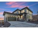Two-story home with a two-car garage at sunset at 17214 W 94Th Ave, Arvada, CO 80007