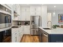 Bright kitchen with stainless steel appliances and white cabinets at 17214 W 94Th Ave, Arvada, CO 80007