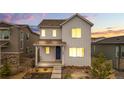 Charming two-story home featuring a modern facade, covered porch, and professionally landscaped front yard at 8028 Williams Fork Ave, Littleton, CO 80125