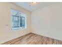 Cozy bedroom with wood floors and a large window providing natural light at 1759 Peak Loop, Broomfield, CO 80023