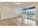 Bright living room with wood floors and sliding glass doors to outdoor deck at 1759 Peak Loop, Broomfield, CO 80023