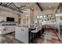 Spacious open kitchen featuring a large island with bar seating, modern appliances, and stylish lighting fixtures at 10106 W 69Th Pl, Arvada, CO 80004