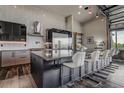 Contemporary kitchen with a large island, sleek cabinets, stainless steel appliances, and stylish barstool seating at 10106 W 69Th Pl, Arvada, CO 80004
