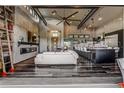 Open-concept living room featuring high ceilings, hardwood floors, modern fireplace, and seamless flow to kitchen at 10106 W 69Th Pl, Arvada, CO 80004
