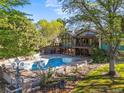 Expansive backyard featuring a large pool, hot tub, mature trees, and lush landscaping at 11510 Lewistown St, Commerce City, CO 80022