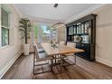 Elegant dining room featuring a modern light fixture, and a large window, adjacent to a spacious dining table and chairs at 805 Elm St, Denver, CO 80220