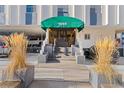Condo entrance with awning, stone planters, and a well-maintained walkway at 1265 Race St # 203, Denver, CO 80206