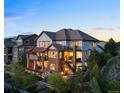 Back of the home with multiple decks and patios, perfect for outdoor entertaining at 10525 Sunshower Pl, Highlands Ranch, CO 80126