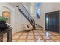 Grand foyer with a winding staircase, tile floors, and ample natural light at 10525 Sunshower Pl, Highlands Ranch, CO 80126