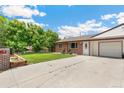 Lovely single-story duplex featuring well-maintained lawn, brick exterior, and a driveway with a garage at 5645 W 5Th Ave # 5645 & 5655, Lakewood, CO 80226
