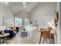 Bright living room featuring vaulted ceilings, a sliding glass door, and natural light at 5950 Gunbarrel Ave # F, Boulder, CO 80301