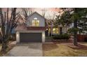 Charming home with a two-car garage and manicured lawn, creating a welcoming curb appeal at sunset at 3206 Columbine Ct, Broomfield, CO 80020