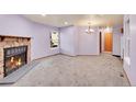 Spacious living room with a cozy fireplace, neutral carpet, and a large window at 922 S Dearborn Way # 8, Aurora, CO 80012
