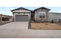 Well-maintained home with a two-car garage, manicured lawn, and inviting curb appeal at 5681 Water Avens Dr, Castle Rock, CO 80104