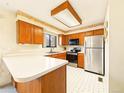 Functional kitchen with stainless steel appliances, light countertops, and a cozy breakfast nook area at 8777 W Cornell Ave # 2, Lakewood, CO 80227