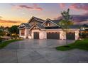 Stunning two-story home with stone accents and a three-car garage at 6561 S Harlan Ct, Littleton, CO 80123