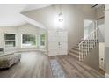 Bright foyer featuring high ceilings, gray-tone floors, staircase, and natural light at 11245 San Joaquin Rdg, Littleton, CO 80127