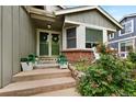 Welcoming front entrance with decorative plants and a charming, covered porch at 11245 San Joaquin Rdg, Littleton, CO 80127