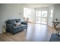 Bright living room with modern flooring and a sliding glass door to the balcony at 17361 E Mansfield Ave # 521R, Aurora, CO 80013