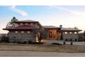 Beautiful two-story home with a red roof and manicured front yard at 24360 E Glasgow Dr, Aurora, CO 80016