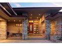 Gorgeous front entrance with stone accents and a cozy seating area at 24360 E Glasgow Dr, Aurora, CO 80016