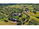 Stunning aerial view of a secluded home surrounded by lush greenery and mountain views at 1380 Oak Valley Rd, Sedalia, CO 80135