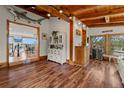 Inviting living area featuring hardwood floors, wooden beams, and a decorative shark hanging on the wall at 1380 Oak Valley Rd, Sedalia, CO 80135