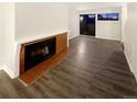 Living room with fireplace and dark laminate flooring at 17054 E Tennessee Dr # 212, Aurora, CO 80017