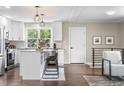 Modern kitchen with white cabinets, stainless steel appliances, and a stylish island with seating at 9220 Yucca Way, Thornton, CO 80229