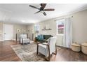 Bright living room featuring hardwood floors, stylish furniture, and ample natural light at 9220 Yucca Way, Thornton, CO 80229