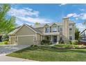 Charming two-story home features a well-maintained lawn, a three-car garage and appealing stone detailing at 7837 Aravon Ct, Lone Tree, CO 80124