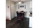 Cozy dining area with a four-person table and dark flooring at 3100 S Federal Blvd # 203, Denver, CO 80236