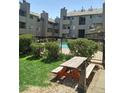 Picnic table with benches in a condo community at 3100 S Federal Blvd # 203, Denver, CO 80236