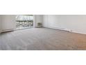 Expansive living room with balcony access and new carpeting, ideal for entertaining at 755 S Alton Way # 8D, Denver, CO 80247