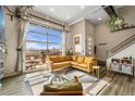 Sun-filled living room featuring modern décor, large windows, and access to the outdoor patio at 10105 Morrison Rd, Lakewood, CO 80227