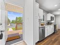 Bright, updated kitchen featuring white cabinets, stainless steel appliances, and a view of the front yard at 1195 S Kendall St, Lakewood, CO 80232