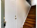 Open entryway featuring wood stairs with metal railings and a glimpse of the interior layout at 7700 W Glasgow Pl # 24C, Littleton, CO 80128