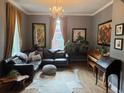 Charming living room with a leather sectional, hardwood floors, and unique decorative touches at 3098 W 39Th Ave, Denver, CO 80211