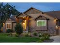 Beautiful single-Gathering home featuring manicured landscaping and a welcoming, covered front porch at 7130 Independence St, Arvada, CO 80004