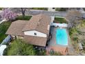 Aerial view of home featuring a spacious backyard, pool, patio, and lush landscaping at 7552 Miller Ct, Arvada, CO 80005