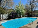 Backyard pool, landscaping, patio and pergola provide a relaxing outdoor experience at 7552 Miller Ct, Arvada, CO 80005