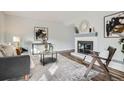 Open concept living area with a fireplace, sleek furniture, and ample natural light at 2729 E Geddes Pl, Centennial, CO 80122