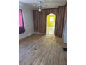 Empty living room showcasing hardwood floors and wood paneled wall at 3816 W Dakota Ave, Denver, CO 80219