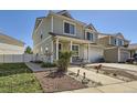 Inviting two-story home with a neatly landscaped front yard and a cozy front porch seating area at 20530 Randolph Pl, Denver, CO 80249