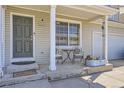 Cozy front porch featuring a seating area with a small table and chairs at 20530 Randolph Pl, Denver, CO 80249