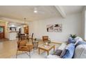 Bright living space featuring light wood floors, neutral walls, a modern ceiling fan, and stylish furniture creating an inviting atmosphere at 1460 Quince Ave # 102, Boulder, CO 80304