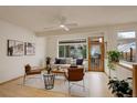 Sunlit living room boasts large windows, light wood floors, stylish furnishings, and indoor plants for a fresh and inviting feel at 1460 Quince Ave # 102, Boulder, CO 80304