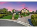 Charming home with lush landscaping, stone accents, and a well-manicured lawn against a beautiful sky at 10037 Allison Ct, Broomfield, CO 80021