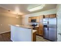 Modern kitchen with stainless steel appliances and convenient breakfast bar at 8083 W 51St Pl # 203, Arvada, CO 80002